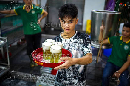 A worker serves Vietnamese draft beer 