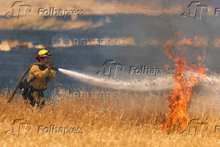 A firefighter battles flames in Woodland California