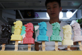 A shopkeeper sells Merlion ice-cream popsicles at Chinatown in Singapore