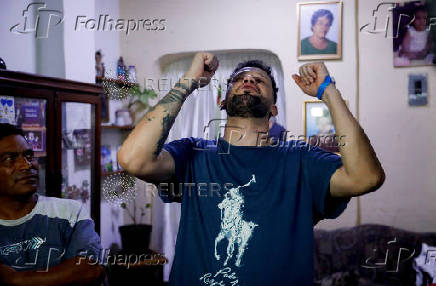 Arturo Suarez, who was held for months in an El Salvador prison, greets family members after his release, in Caracas
