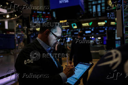 A trader works on the floor at the New York Stock Exchange (NYSE) in New York City