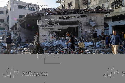Palestinians inspect destroyed building after Israeli airstrike in Gaza City