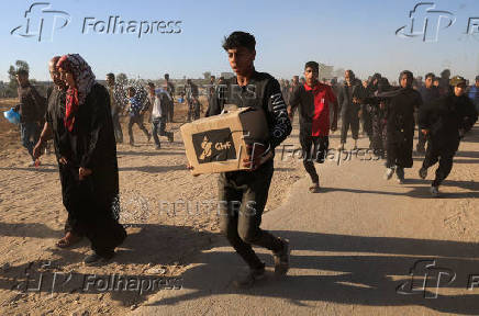 Palestinians receive aid from the U.S.-backed Gaza Humanitarian Foundation, in Khan Younis