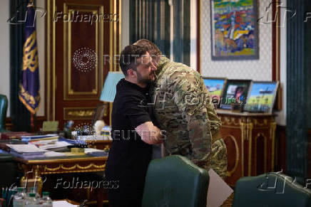 Ukraine's President Zelenskiy and Head of the Security Service of Ukraine Maliuk embrace each other during their meeting in Kyiv