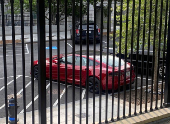 A Tesla vehicle is parked on West Executive Avenue near the White House in Washington