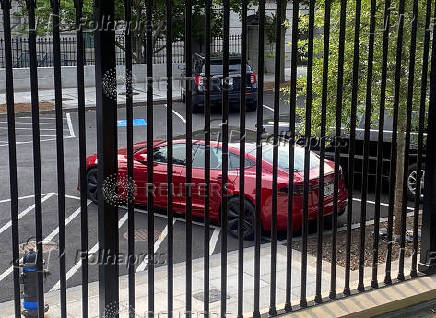 A Tesla vehicle is parked on West Executive Avenue near the White House in Washington