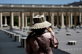 A woman in the Palais-Royal Gardens on a warm and sunny spring day in Paris