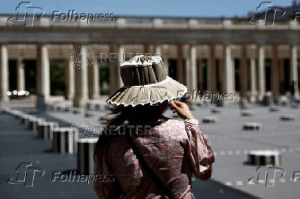 A woman in the Palais-Royal Gardens on a warm and sunny spring day in Paris
