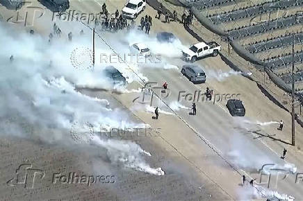 Tear gas billows from cannisters thrown by federal agents, during an immigration raid on an agricultural facility in Camarillo