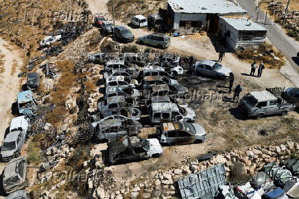 A view show burnt cars, after Israeli settlers set fire to cars in the Palestinian town of Burqa
