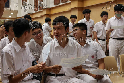Secondary school students react after receiving their Diploma of Secondary Education (DSE) exam results in Hong Kong