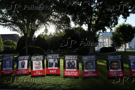 Posters of people described as arrested illegal immigrants are displayed outside the White House in Washington