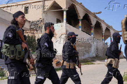 Syrian security forces deployed in the village of Al-Soura al-Kubra
