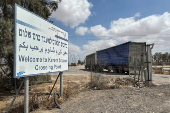 Trucks carrying aid are seen at the Kerem Shalom crossing between Israel and Gaza, on its Israeli side