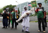Activists attend a protest against Israel and in support of Palestinians in Gaza, outside the U.S. embassy in Jakarta