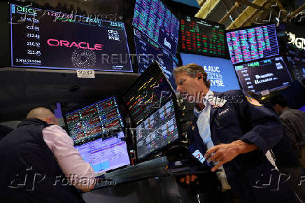 FILE PHOTO: Traders work on the floor of the NYSE in New York