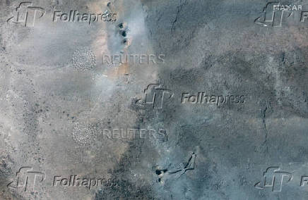 A closer satellite view shows holes and craters on a ridge at Fordow underground complex, after the U.S. struck the underground nuclear facility, near Qom