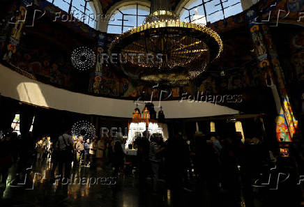Worshippers gather for the celebrations for the Passion of the Lord at the Church of Saint Clement of Ohrid, on Good Friday, in Skopje