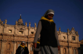 Nuns walk in front of St. Peter's Basilica in St. Peter's Square ahead of the conclave, which will be held on May 7, at the Vatican