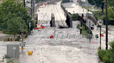 Floodwater runs onto the railway tracks