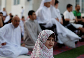 Palestinians from Gaza attend Eid al-Adha prayers, at Al Thumama Complex,  in Doha