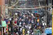People shop at a market ahead of the Eid al-Adha festival in the old quarters of Delhi