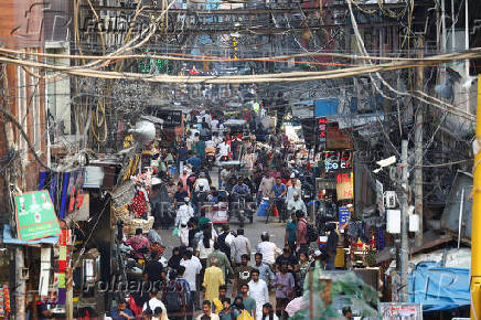 People shop at a market ahead of the Eid al-Adha festival in the old quarters of Delhi