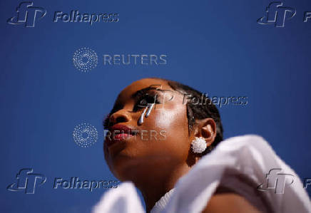 A model takes part in a fashion competition during the Durban July horse race in Durban