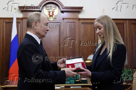 Russian President Putin hands Gold Star medal to wife of killed Major General Gudkov, in Moscow
