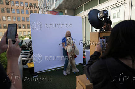 Moviegoer Terre and her dog Shai pose for a photo before a special screening of the film Superman in Los Angeles
