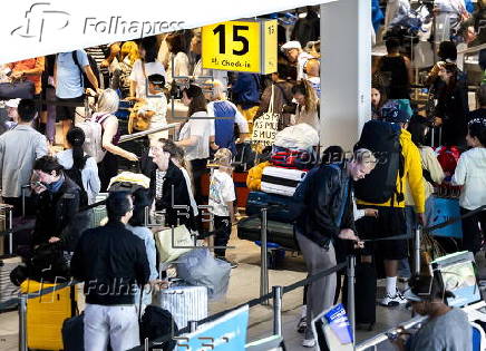 Travelers with their luggage at Schiphol Airport near Amsterdam