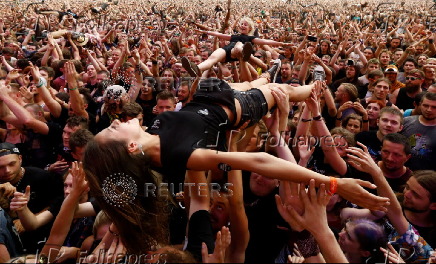 Revelers crowd surf during the 23rd Woodstock Festival in Kostrzyn-upon-Odra, Poland