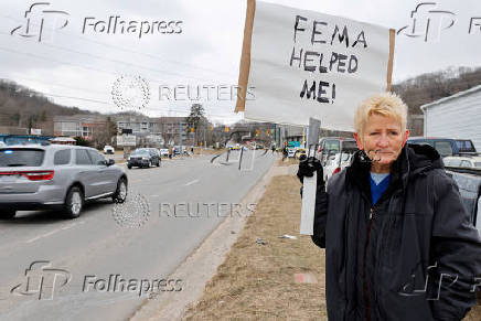 FILE PHOTO: FEMA recipient holds sign in support of the government disaster agency as Trump visits North Carolina