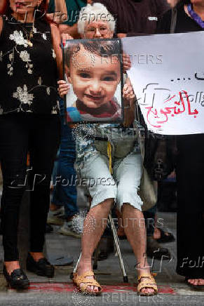 People take part in a protest against what organizers call 