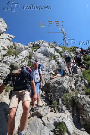 Hikers on the Giewont summit in the Tatra Mountains
