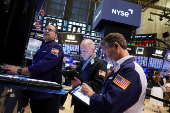 Traders work on the floor at the New York Stock Exchange, in New York City