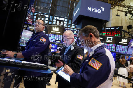 Traders work on the floor at the New York Stock Exchange, in New York City