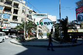 Man walks at Al-Karama Square in Jaramana