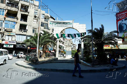 Man walks at Al-Karama Square in Jaramana