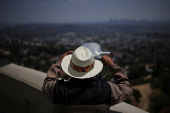 A visitor looks through a telescope at the Griffith Observatory in Los Angeles
