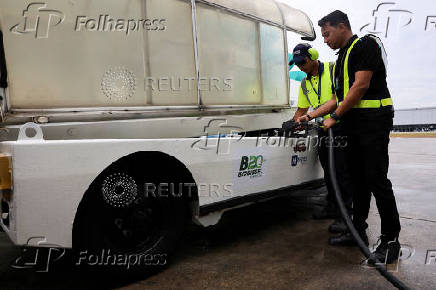 Ground crew refuel the mobile luggage conveyor with B20 biodiesel in Sepang