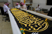 Workers prepare the Kiswa, a silk cloth that covers the Kaaba, ahead of the annual hajj pilgrimage