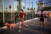 People to shelter opposite to the Meditarenean beach as siren sounds following missile attack from Iran on Israel, in Tel Aviv