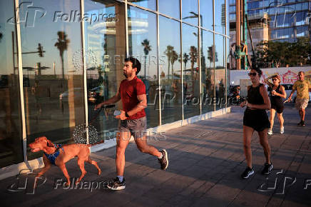 People to shelter opposite to the Meditarenean beach as siren sounds following missile attack from Iran on Israel, in Tel Aviv