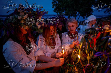 People take part in a celebration on the traditional Ivana Kupala in the village of Vytachiv, in Kyiv region