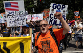 Activists rally during an anti-Trump protest march to the White House in Washington