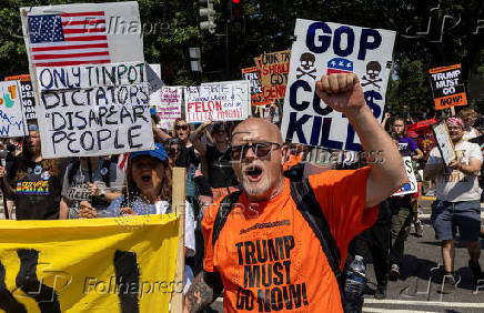 Activists rally during an anti-Trump protest march to the White House in Washington