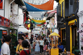 People walk through a shopping street at Kampong Glam district in Singapore