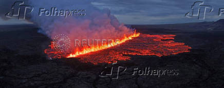 Lava emerges through a fissure following a volcano eruption near Grindavik