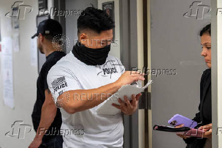 A migrant is detained by federal immigration officers at U.S. immigration court